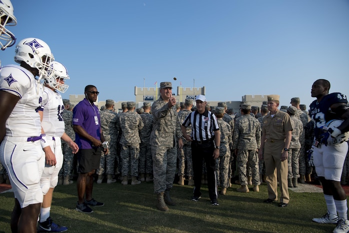 Col. Robert Lyman, Joint Base Charleston commander, performs the coin toss prior to the football game between the Citadel Bulldogs and Furman Paladins as Navy Capt. Robert Hudson, Joint Base Charleston deputy commander (right), looks on Sept. 10, 2016. The pregame festivities also included an aerial demonstration by the Army Golden Knights and a formation of service members from Joint Base Charleston.