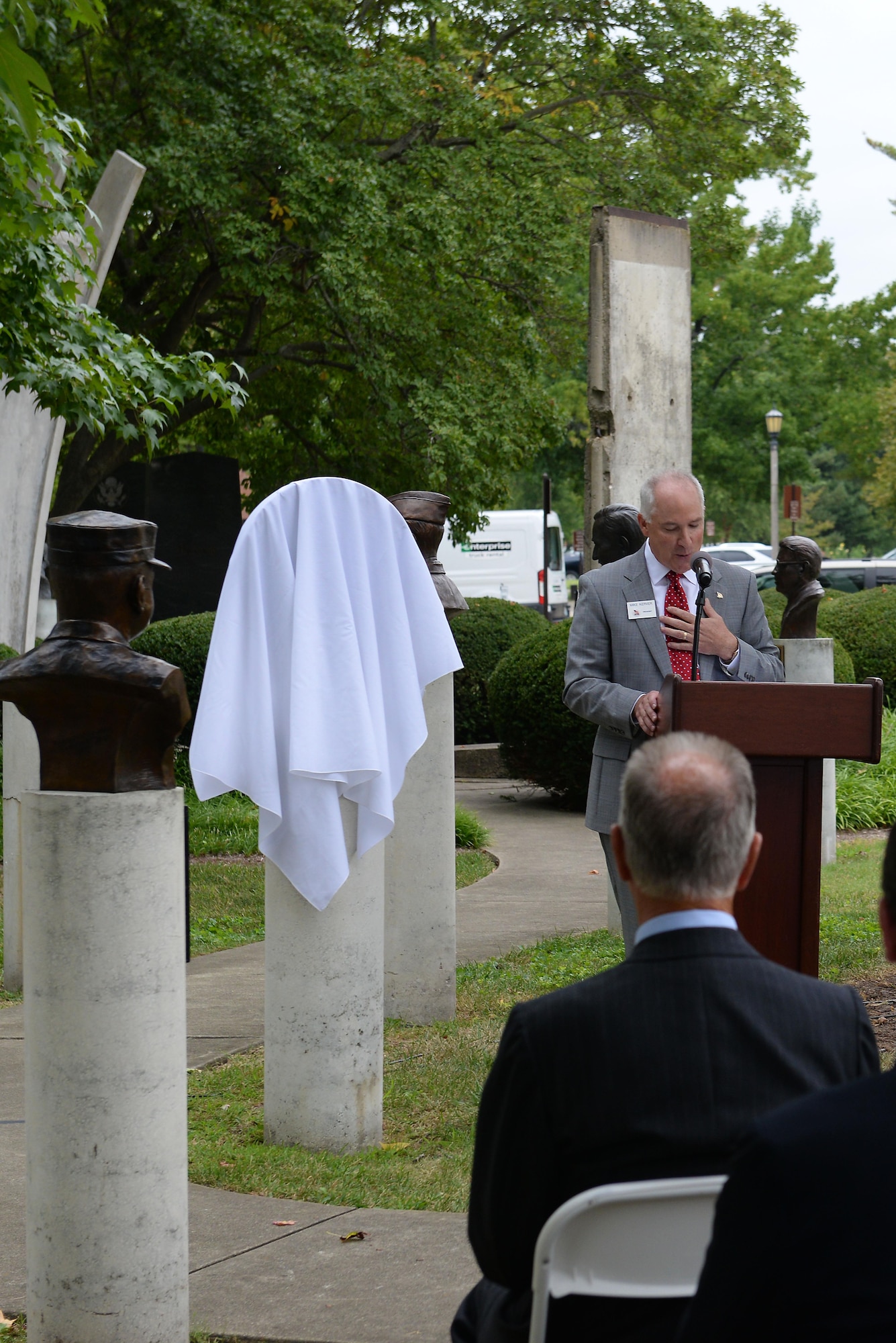Retired Chief Master Sgt. Mike Kerver, President of the Airlift/Tanker Association, speaks to a crowd during a ceremony in the Mobility Memorial Park at Scott Air Force Base, Illinois, Sept. 8, 2016. The ceremony took place to honor six C-17A “Pathfinder Loadmasters,” eternalized on a large bronze medallion as part of the Mobility Memorial Park. The honorees were a vital part of ensuring that the one-loadmaster aircrew concept became a reality on the C-17A. This loadmaster group led the way to design improvements and advancement to America’s airlift capability and set a benchmark for air mobility aircraft for years to come. (U.S. Air Force photo by Senior Airman Erica Fowler)