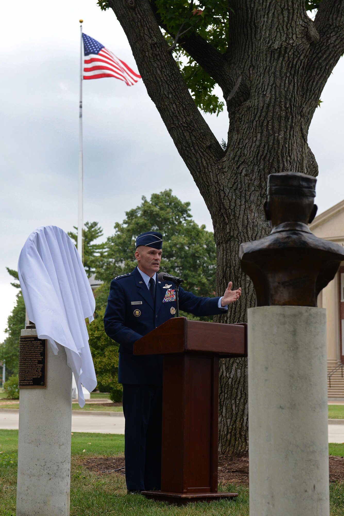 Gen. Carlton D. Everhart II, Commander, Air Mobility Command, speaks to a crowd during a ceremony in the Mobility Memorial Park at Scott Air Force Base, Illinois, Sept. 8, 2016. The ceremony took place to honor six C-17A “Pathfinder Loadmasters,” eternalized on a large bronze medallion as part of the Mobility Memorial Park. The honorees were a vital part of ensuring that the one-loadmaster aircrew concept became a reality on the C-17A. This loadmaster group led the way to design improvements and advancement to America’s airlift capability and set a benchmark for air mobility aircraft for years to come. (U.S. Air Force photo by Senior Airman Erica Fowler)
