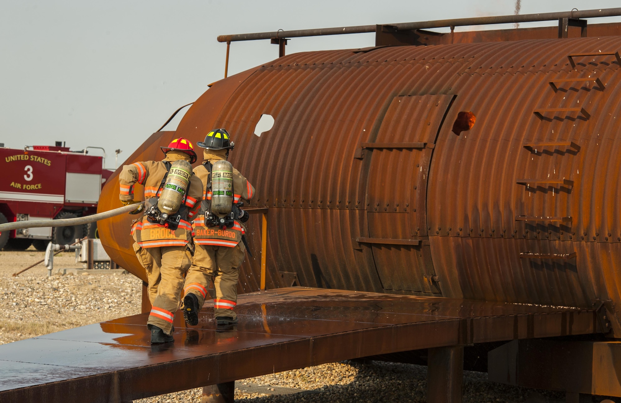 Airman 1st Class Alisa Baker-Burdo, 5th Civil Engineer Squadron firefighter, leads the way into a burning B-52 simulator during training at Minot Air Force Base, N.D., Sept. 1, 2016. Baker-Burdo doesn’t let the fact that she’s one of the few female firefighters in the Air Force get in the way of her excelling in her tough career field. (U.S. Air Force photo/Airman 1st Class Christian Sullivan)