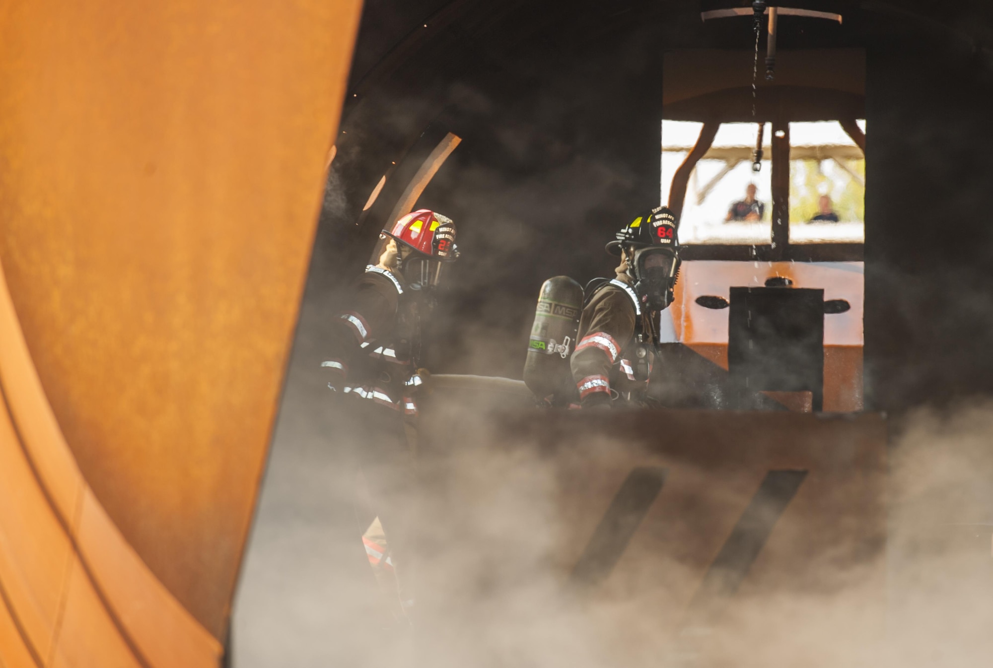 Airman First Class Alisa Baker-Burdo (right), 5th Civil Engineer Squadron firefighter, puts out a fire during a training exercise at Minot Air Force Base, N.D., Sept. 1, 2016. Baker-Burdo is the only female firefighter in the 5th CE fire department. (U.S. Air Force photo/Airman 1st Class Christian Sullivan)