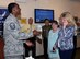 Master Sgt. Rodney McInnis, Airman and Family Readiness Center readiness noncommissioned officer, hands Cheryl Roberson a huggable uniform gift Sept. 12, 2016, at Columbus Air Force Base, Mississippi. HUGs are made for families of deployed members.  The keepsake includes the deployed member’s image and plays a personalized message from the deployed member. (U.S. Air Force photo by Sharon Ybarra)