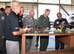 Jeff Davis, L3 Vertex Aerospace T-6 lead mechanic, briefs Lt. Gen. Darryl Roberson, commander of Air Education and Training Command, Chief Master Sgt. David Staton, AETC command chief, and base leaders, about T-6 landing gear trunnion fittings Sept. 12, 2016, at Columbus Air Force Base, Mississippi. Roberson had the opportunity to get an extensive look at what makes the T-6 an aerial asset for AETC. (U.S. Air Force photo by Elizabeth Owens)