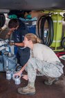 U.S. Air Force Senior Airman Jessica Hand, 7th Bomb Wing defensive avionics systems specialist, uncaps a can of oil for use during maintenance work on the B-1B Lancer in preparation for a planned flight at Royal Air Force Base Fairford, England, Sept. 7, 2016.   Hand, is deployed to RAF Fairford to participate in Exercise Ample Strike, a Czech Republic led, 18-nation live exercise. (U.S. Air Force photo by 1st Lt. Monique Roux/Released)