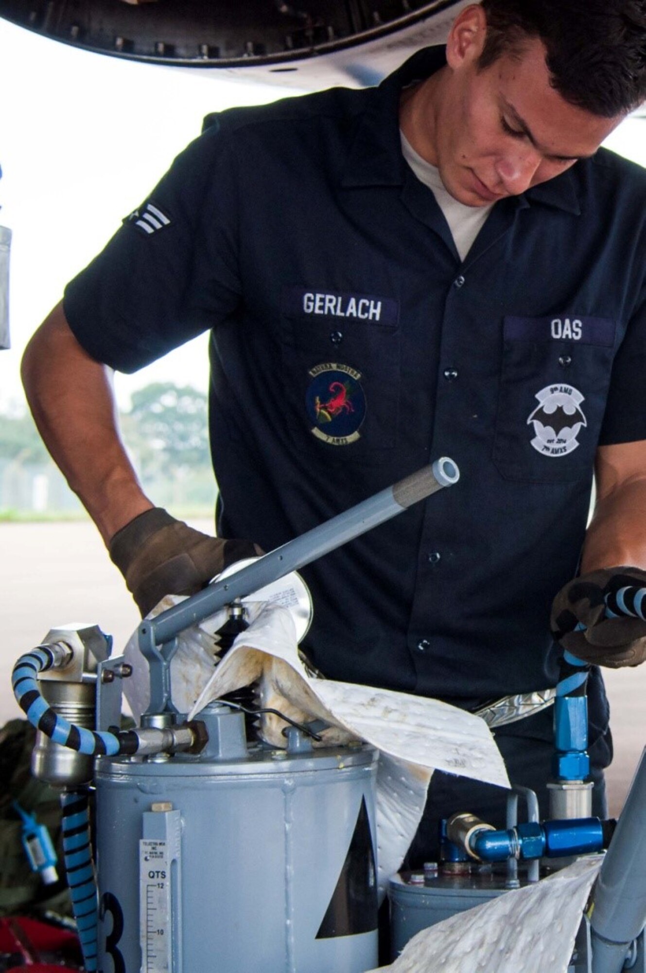 U.S. Air Force Senior Airman Eric Gerlach, 7th Bomb Wing offensive avionics systems specialist, adds oil to the B-1B Lancer during routine maintenance at Royal Air Force Fairford, England, Sept. 7, 2016. Gerlach is deployed to RAF Fairford to participate in Exercise Ample Strike, a Czech Republic led, 18 nation live exercise. (U.S. Air Force photo by 1st Lt. Monique Roux/Released)
