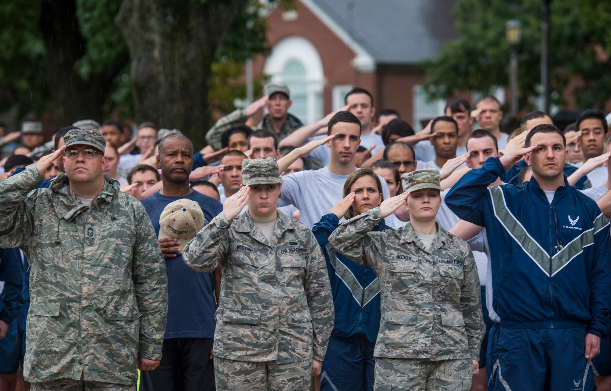 Members of Scott Air Force Base salute as the American flag is brought to half-mast during Reveille, Scott Air Force Base, Ill., Sept. 9, 2016.  (U.S. Air Force photo by Staff Sgt. Jodi Martinez)