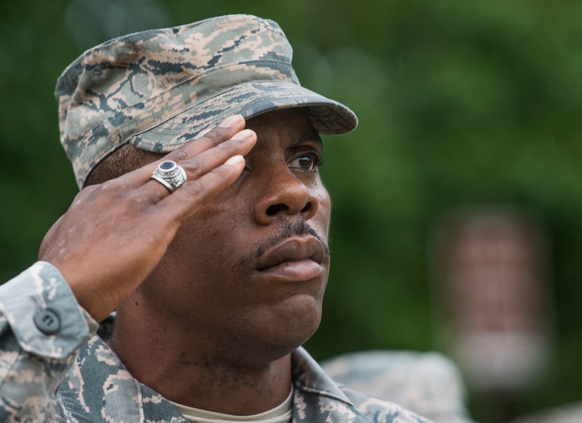 Senior Master Sgt. James Hart, 375th Air Mobility Wing Public Affairs, salutes as the American flag is brought to half-mast during Reveille, Scott Air Force Base, Ill., Sept. 9, 2016.  (U.S. Air Force photo by Staff Sgt. Jodi Martinez)