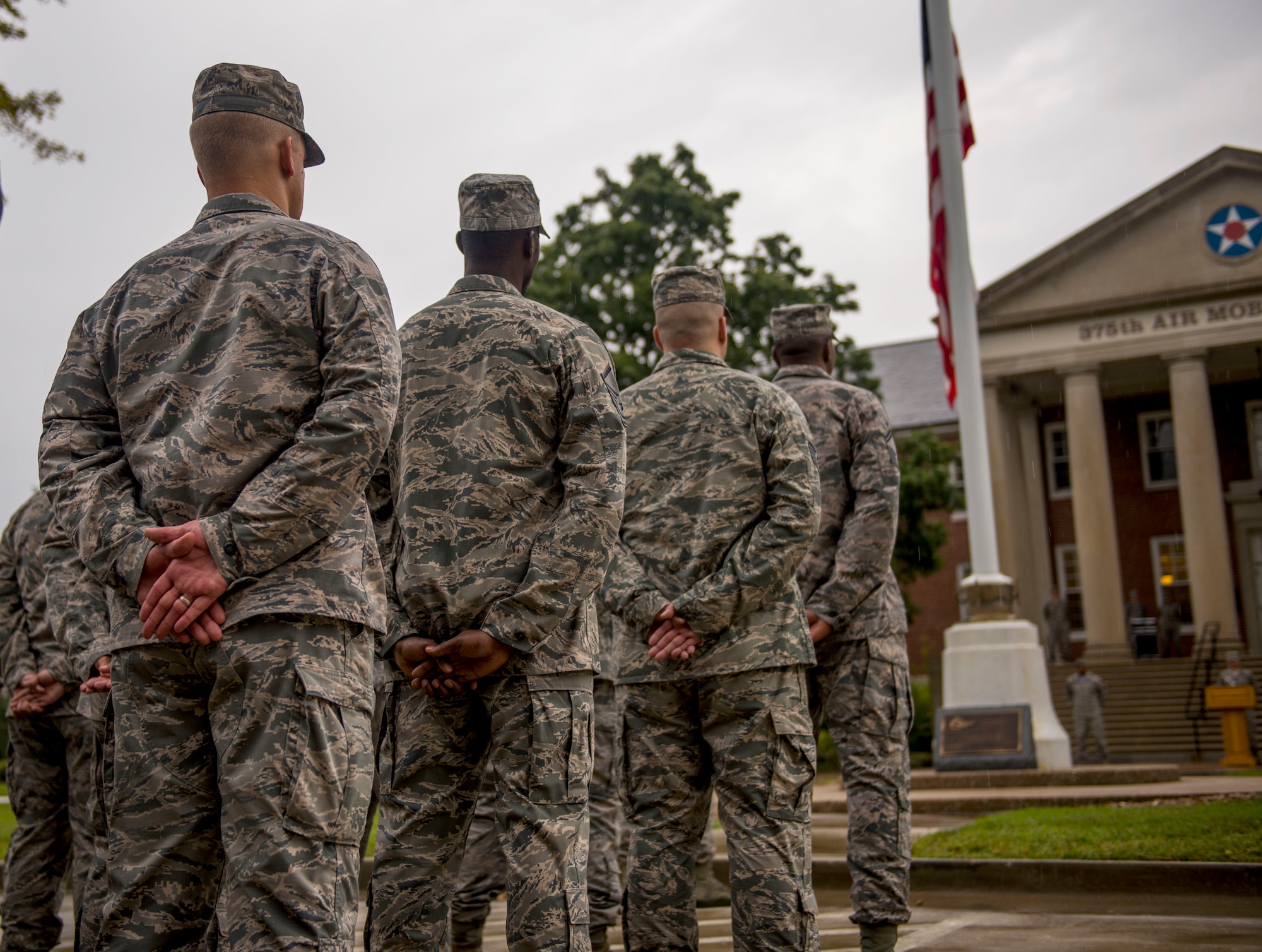 A formation stands at parade rest after the American flag was brought to half-mast during Reveille, Scott Air Force Base, Ill., Sept. 9, 2016.  (U.S. Air Force photo by Staff Sgt. Jodi Martinez)