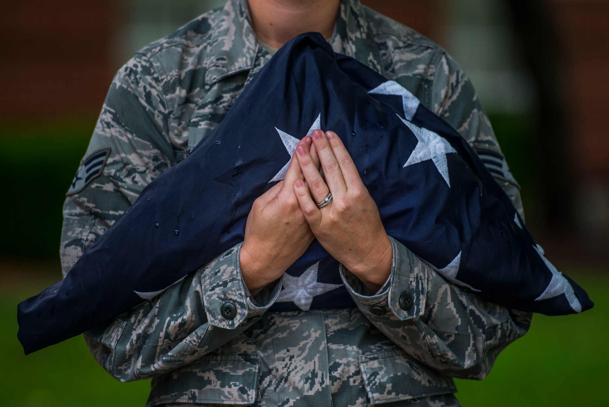 Senior Airman Class Rachel Ollie, 375th Communications Squadron, holds the American flag prior to Reveille, Scott Air Force Base, Ill., Sept. 9, 2016. (U.S. Air Force photo/Staff Sgt. Jodi Martinez)