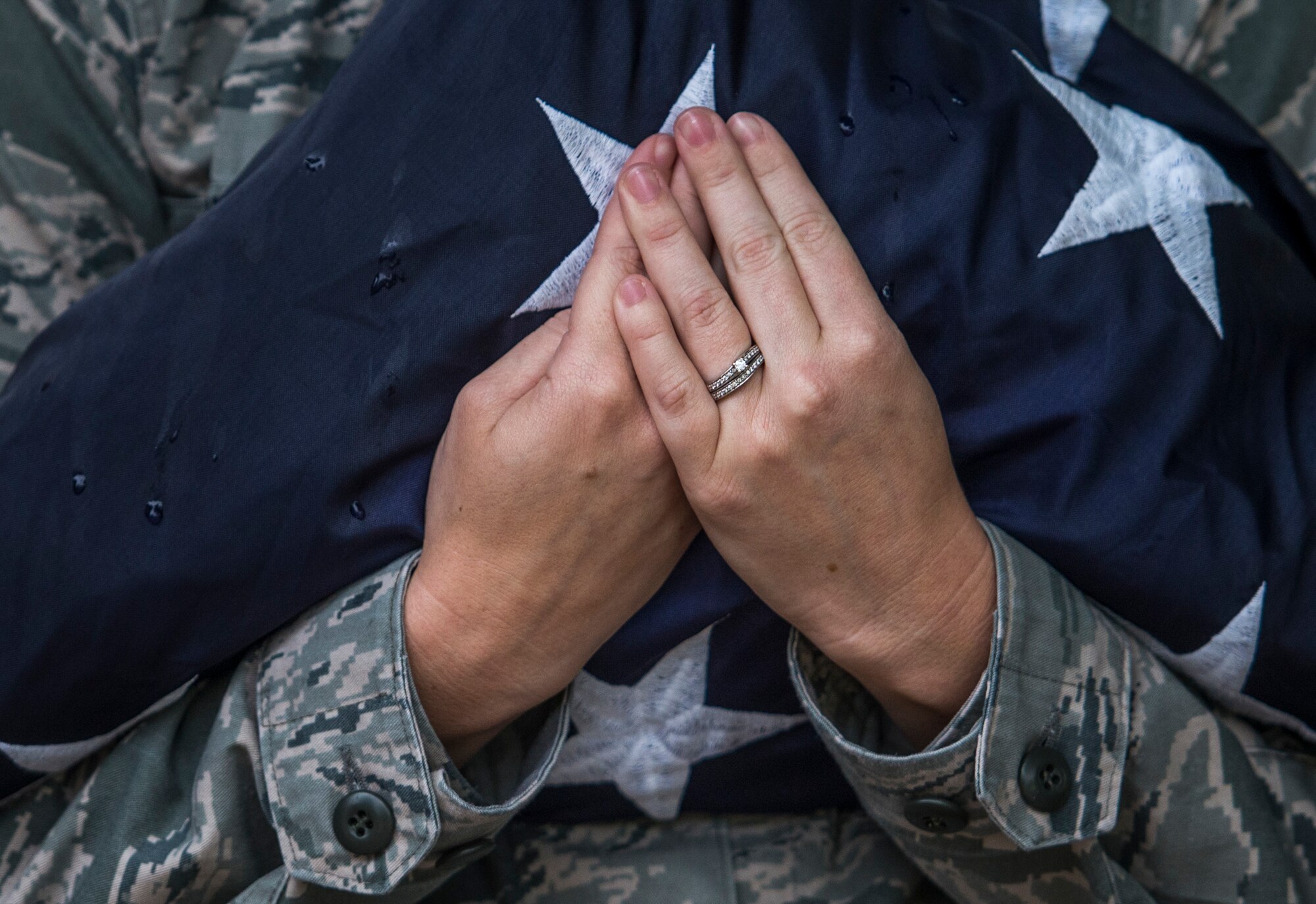 Senior Airman Class Rachel Ollie, 375th Communications Squadron, holds the American flag prior to Reveille, Scott Air Force Base, Ill., Sept. 9, 2016. (U.S. Air Force photo/Staff Sgt. Jodi Martinez)