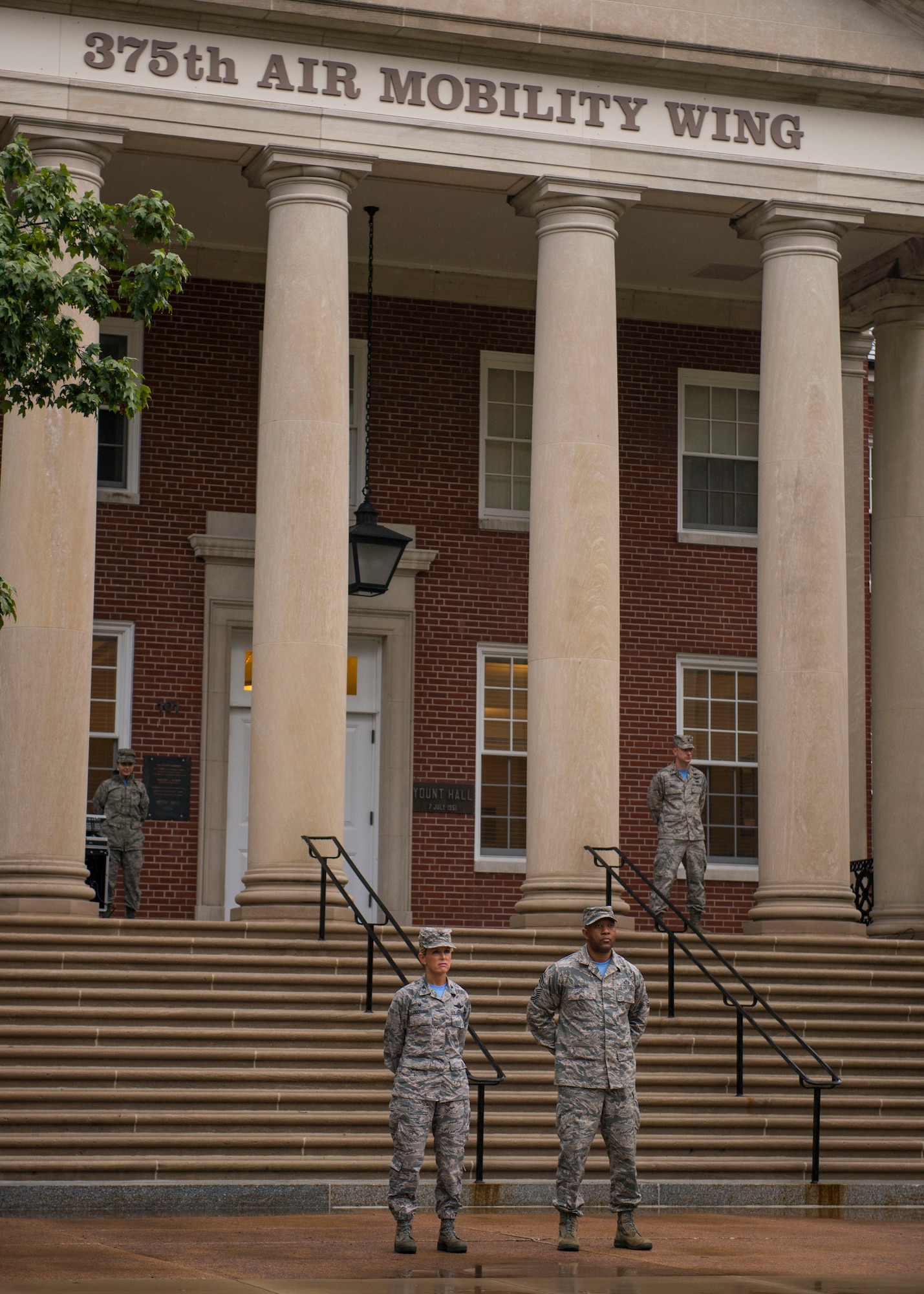 Col. Laura Lenderman, 375th Air Mobility Wing Commander, and Chief Master Sgt. Wesley Mathias, 375th Air Mobility Wing Command Chief, stand at parade rest in front of the 375th Air Mobility Wing building for Reveille, Scott Air Force Base, Ill., Sept. 9, 2016. (U.S. Air Force photo/Staff Sgt. Jodi Martinez)