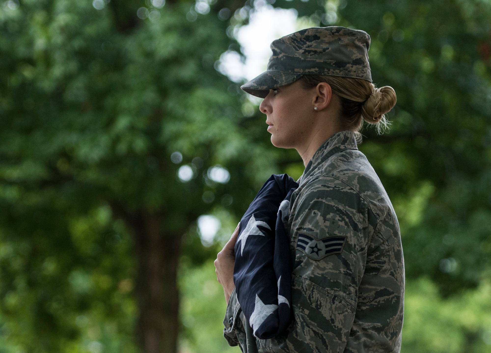 Senior Airman Class Rachel Ollie, 375th Communications Squadron, holds the American flag during Reveille, Scott Air Force Base, Ill., Sept. 9, 2016. (U.S. Air Force photo/Staff Sgt. Jodi Martinez)