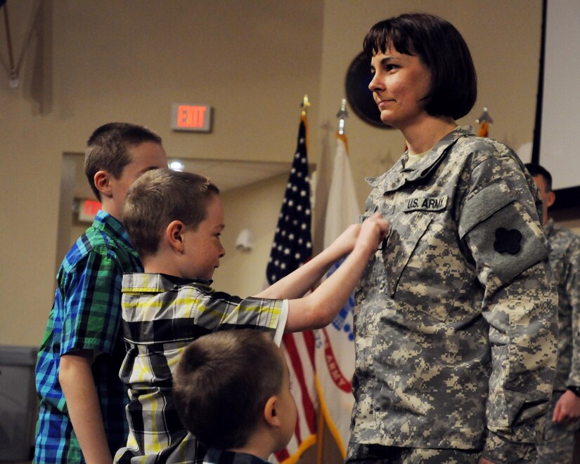 Sgt. Rachelle Witherow, 88th Regional Support Command, receives a promotion with the help of her three sons during a ceremony at the 88th RSC Headquarters on Fort McCoy, Wis., April 3, 2015. (U.S. Army Reserve photo courtesy of Sgt. 1st Class Corey Beal)
