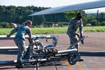 U.S. Air Force Senior Airman Rachel Lockwood and Airman First Class Christopher Broome push a pantograph into place for refueling a B52H Stratofortess after landing at Royal Air Force Fairford, England, Sept. 8, 2016.  Lockwood, assigned to the 307th Logistics Readiness Squadron, Barksdale AFB, La., and Broome, assigned to the 7th Logistics Readiness Squadron, Dyess AB, Texas, are deployed to RAF Fairford to participate in Exercise Ample Strike, a Czech Republic led, 18 nation live exercise. (U.S. Air Force photo by 1st Lt. Monique Roux/Released)