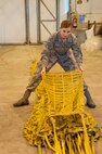 U.S. Air Force Staff Sgt. Megan Kay, 307th Bomb Wing aircraft flight equipment specialist, straightens one of 24 panels of the parachute used to slow a B52H Stratofortess after landing at Royal Air Force Fairford, England, Sept 8, 2016.    Kay is one of dozens of airmen deployed to RAF Fairford to participate in Exercise Ample Strike, a Czech Republic led, 18 nation live exercise. (U.S. Air Force photo by 1st Lt. Monique Roux/Released)
