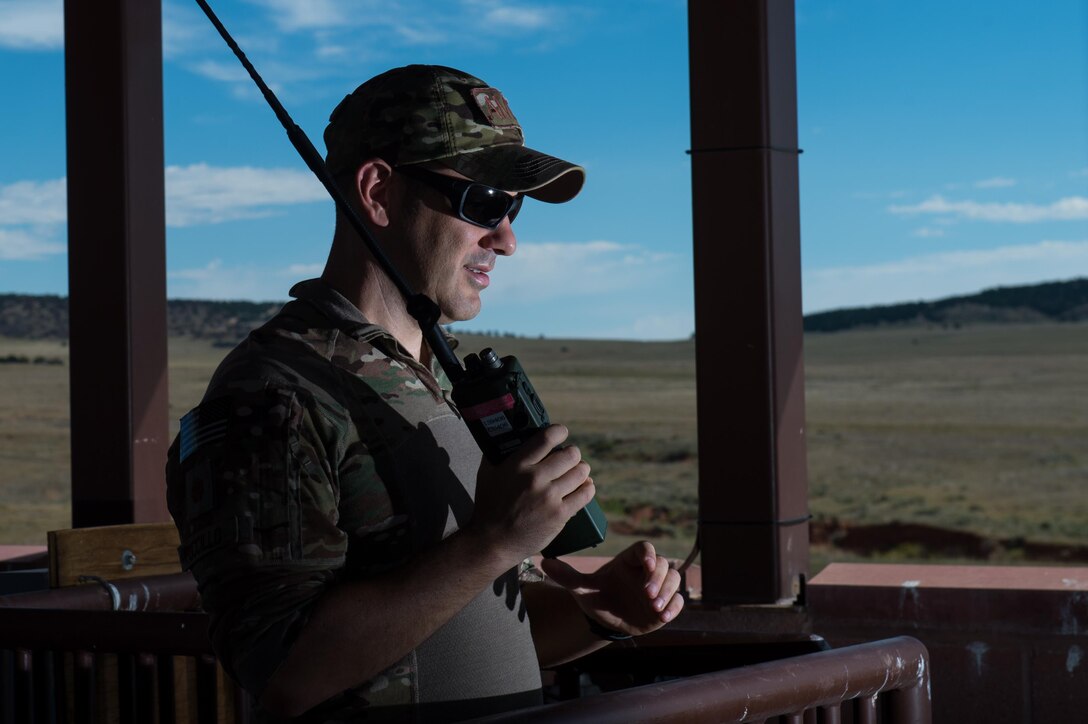 U.S. Air Force Maj. John Fuccillo, an air mobility liaison officer with the 621st Mobility Support Operations Squadron assigned to the U.S. Army's 4th Infantry Division at Fort Carson, Colorado, communicates with C-130 Hercules crew members over the radio during Cerberus Strike 16-02 at the Red Devil Landing Zone, Colorado, Sept. 12, 2016. C-Strike is a joint exercise where contingency response forces rehearse potential real-world situations by training with Army counterparts in cargo uploading and downloading on aircraft, aircraft engine running off-loads, communications, aerial port procedures, and air mobility liaison officer operations with airdrops from aircraft. (U.S. Air Force photo by Master Sgt. Joseph Swafford)