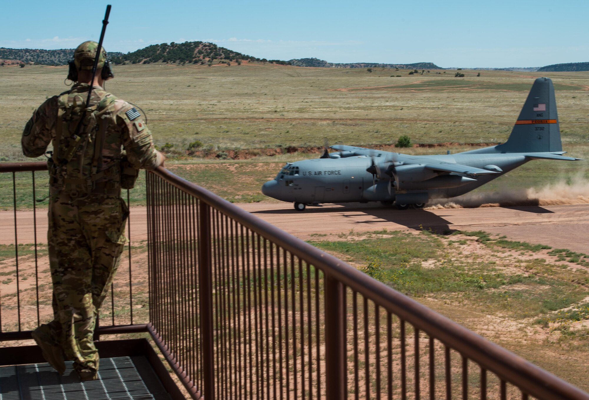 U.S. Air Force Maj. John Fuccillo, an air mobility liaison officer with the 621st Mobility Support Operations Squadron assigned to the U.S. Army's 4th Infantry Division at Fort Carson, Colorado, looks on as a C-130 Hercules takes off during Cerberus Strike 16-02 at the Red Devil Landing Zone, Colorado, Sept. 12, 2016. C-Strike is a joint exercise where contingency response forces rehearse potential real-world situations by training with Army counterparts in cargo uploading and downloading on aircraft, aircraft engine running off-loads, communications, aerial port procedures, and air mobility liaison officer operations with airdrops from aircraft. (U.S. Air Force photo by Master Sgt. Joseph Swafford)