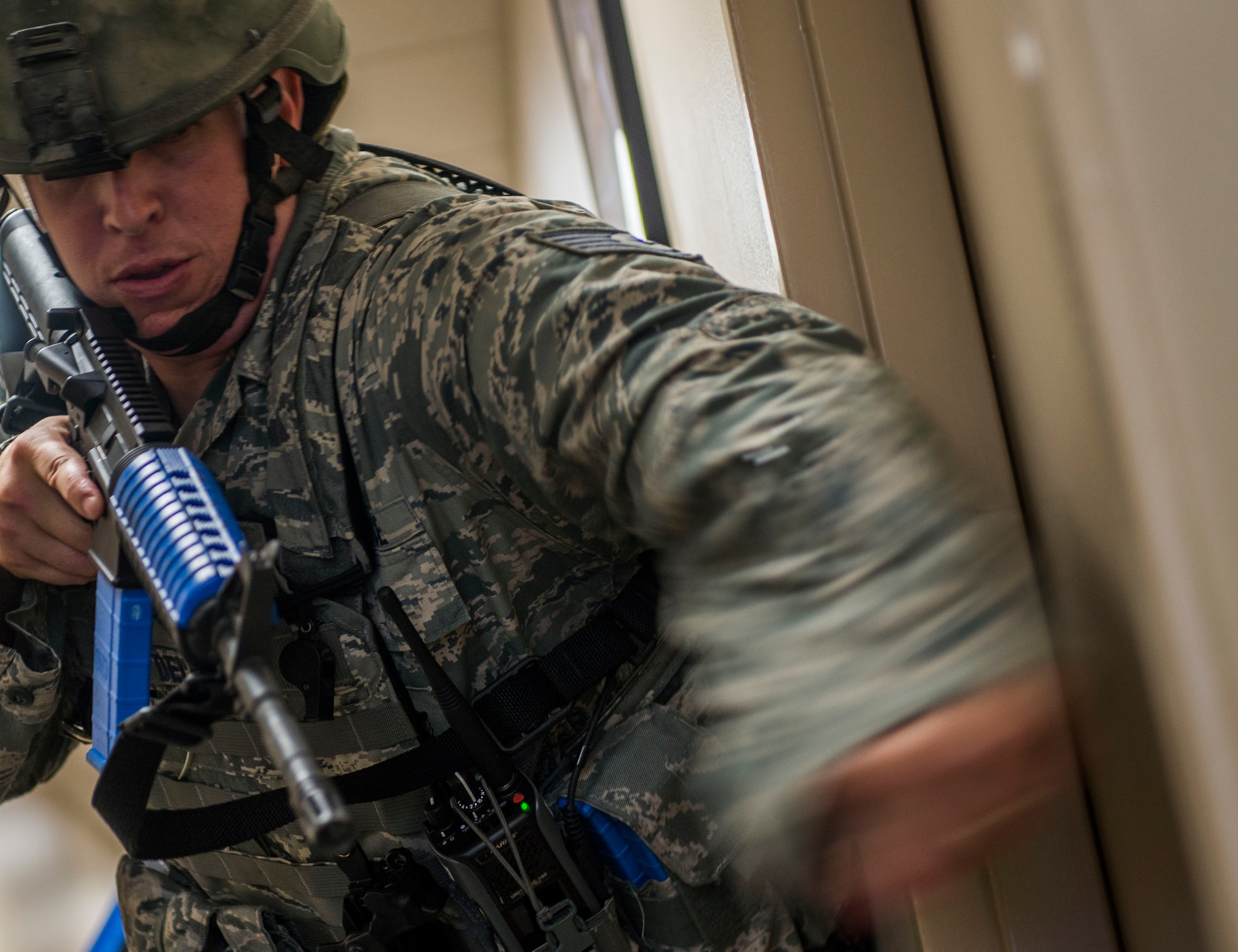 Tech. Sgt. Bryan Dell, 375th Security Forces Squadron, bangs on a door during an active shooter exercise, Scott Air Force Base, Ill., Sept. 9, 2016.  With an increase of mass shootings, the Department of Defense has trained personnel and first responders on how to respond in an active shooter situation.