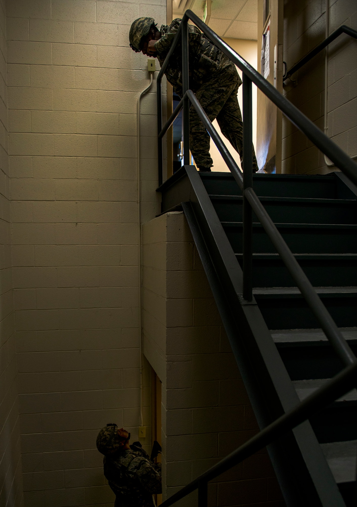 Tech. Sgt. Jeremy McCarty, 375th Security Forces Squadron, communicates with another first responder during an active shooter exercise, Scott Air Force Base, Ill., Sept. 9, 2016.  With an increase of mass shootings, the Department of Defense has trained personnel and first responders on how to respond in an active shooter situation.