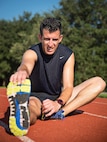 Master Sgt. Tito Carrillo, 433rd Aeromedical Evacuation Squadron flight medic, stretches after completing interval training Sept. 1, 2016 at Joint Base San Antonio-Lackland, Texas. Carrillo was selected to run on the 2016 Air Force Reserve Command's Challenge Team. The team is comprised of 10 marathon runners who will compete with other Air Force major commands in the half and full marathon at the 20th annual Air Force Marathon Sept. 17, 2016 at Wright-Patterson Air Force Base, Ohio. (U.S. Air Force photo by Benjamin Faske)