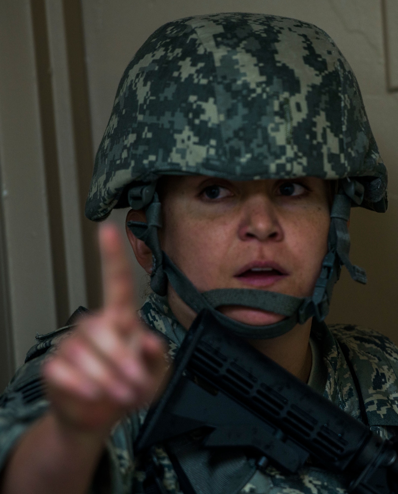 Staff Sgt. Alexa Marro, 375th Security Forces Squadron, signals for another individual to follow during an active shooter exercise, , Scott Air Force Base, Ill., Sept. 9, 2016.  With an increase of mass shootings, the Department of Defense has trained personnel and first responders on how to respond in an active shooter situation.