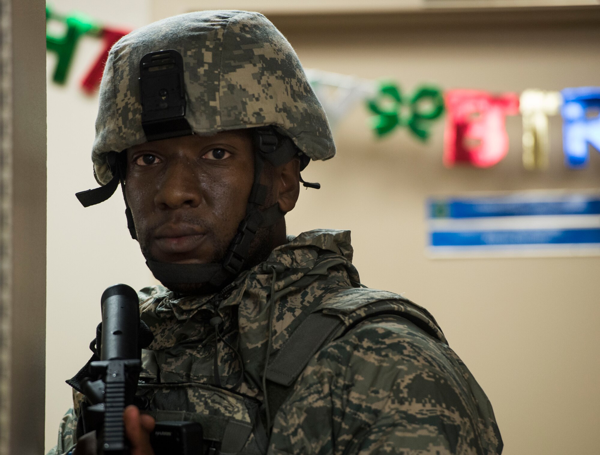 Tech. Sgt. Jeremy McCarty, 375th Security Forces Squadron, guards a hallway during an active shooter exercise, Scott Air Force Base, Ill., Sept. 9, 2016.  With an increase of mass shootings, the Department of Defense has trained personnel and first responders on how to respond in an active shooter situation.