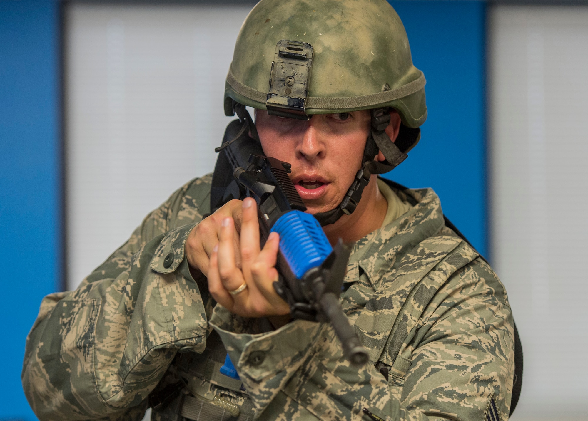 Tech. Sgt. Bryan Dell, 375th Security Forces Squadron, scans cubicles for threats during an active shooter exercise, Scott Air Force Base, Ill., Sept. 9, 2016.  With an increase of mass shootings, the Department of Defense has trained personnel and first responders on how to respond in an active shooter situation.