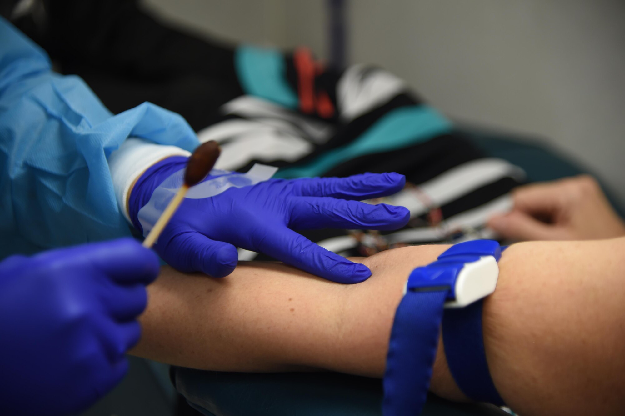 A phlebotomy technician checks a donor's veins before applying betadine during a blood drive at Joint Base Elmendorf-Richardson, Alaska, Sept. 14, 2016. Each year, 4.5 million Americans need a blood transfusion. 