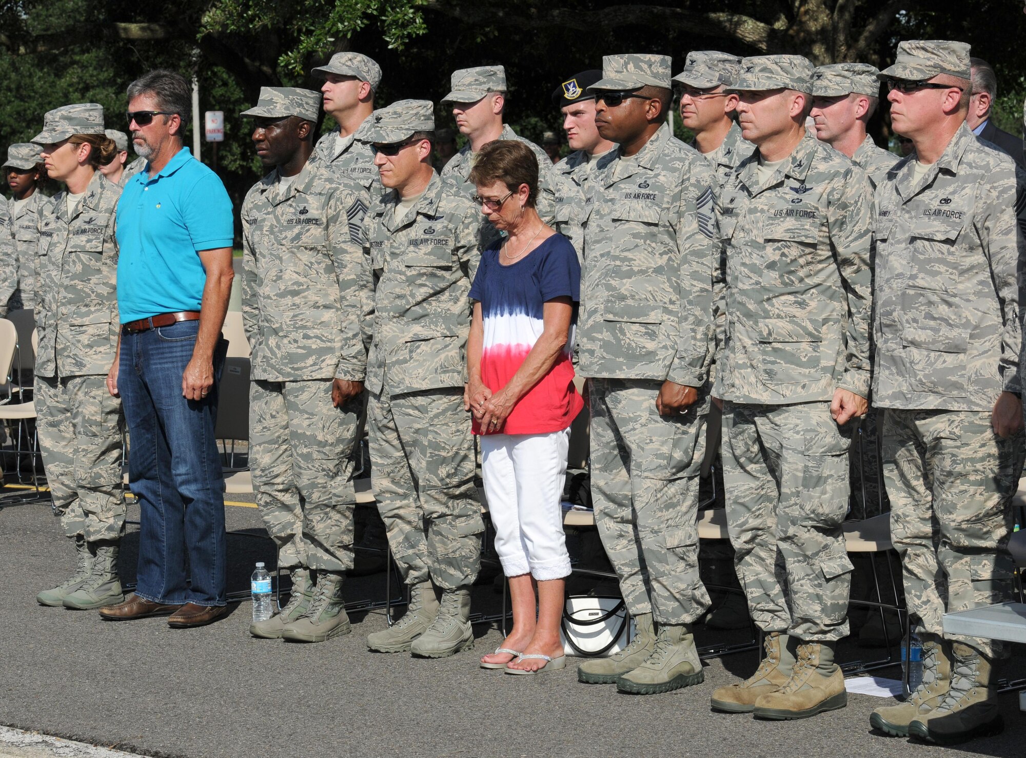 Second Air Force, 81st Training Wing and 403rd Wing leadership stand at attention during a 9/11 memorial ceremony, Sept. 12, 2016, on Keesler Air Force Base, Miss. Fifteen years ago on Sept. 11, 2001, 19 terrorists simultaneously hijacked four passenger jets; flying one into the Pentagon in Washington, D.C., two into the World Trade Center in New York City, New York and one crashing outside of Shanksville, Pa. A total of 2,996 people were killed in the attacks.  (U.S. Air Force photo by Kemberly Groue/Released)