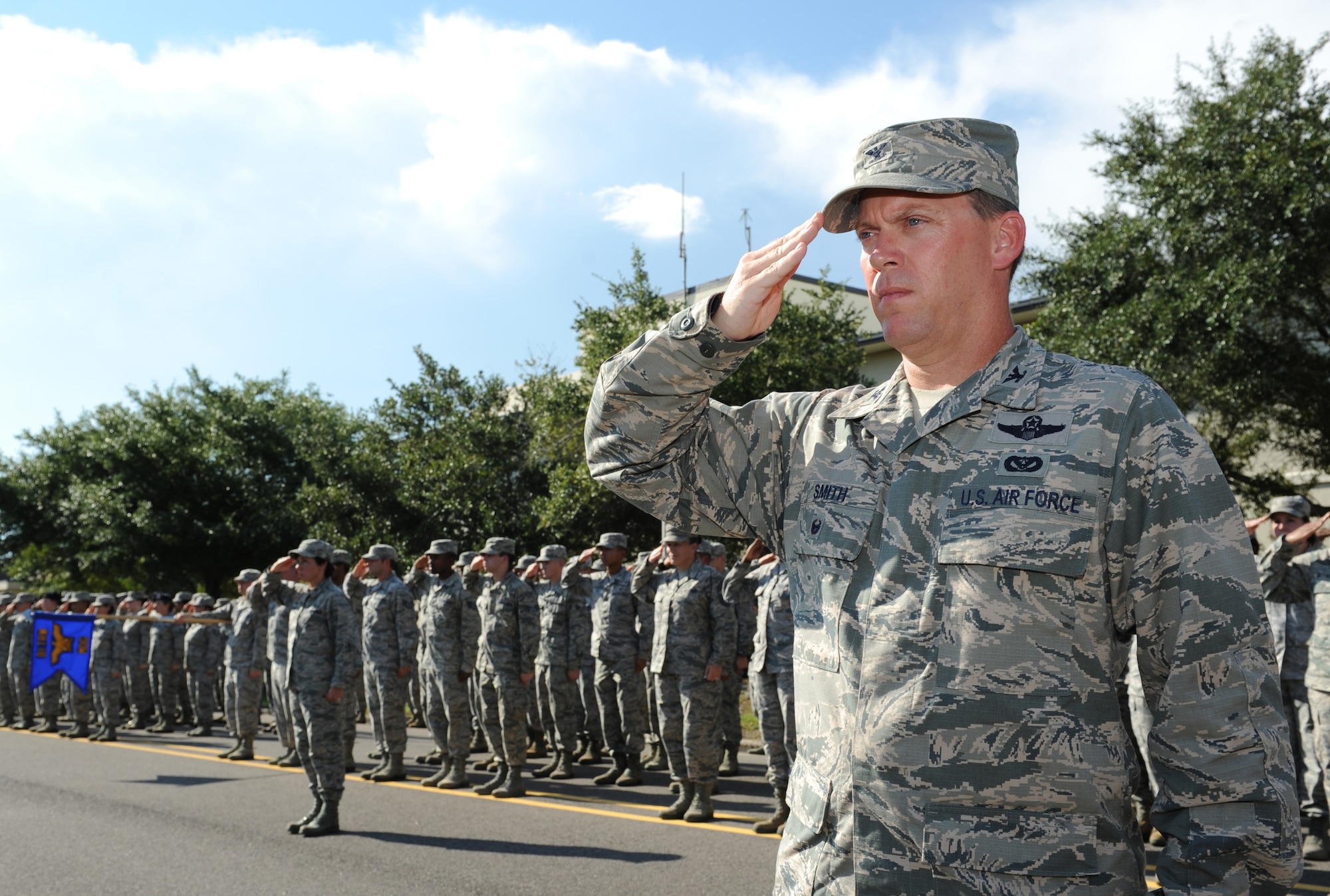 Col. C. Mike Smith, 81st Training Wing vice commander, renders a salute during a 9/11 memorial ceremony, Sept. 12, 2016, on Keesler Air Force Base, Miss. Fifteen years ago on Sept. 11, 2001, 19 terrorists simultaneously hijacked four passenger jets; flying one into the Pentagon in Washington, D.C., two into the World Trade Center in New York City, New York and one crashing outside of Shanksville, Pa. A total of 2,996 people were killed in the attacks.  (U.S. Air Force photo by Kemberly Groue/Released)