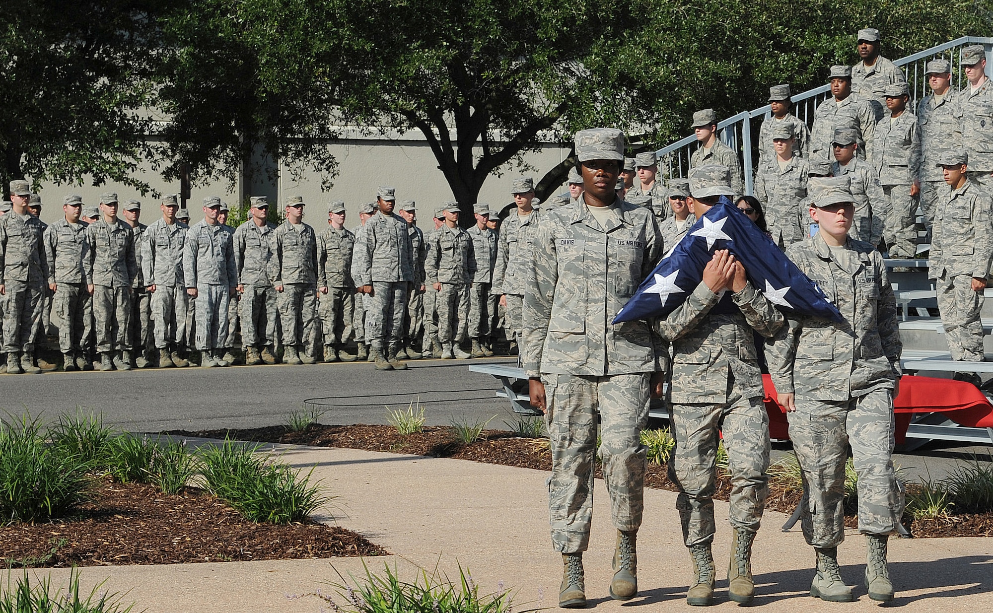 Tech. Sgt. Amber Davis, 81st Diagnostic and Therapeutics Squadron radiology technician  and Airmen 1st Class Devon Montoya81st, and Ashley Kennedy, 81st MDTS radiology technicians, carry the U.S. flag during a 9/11 memorial ceremony, Sept. 12, 2016, on Keesler Air Force Base, Miss. Fifteen years ago on Sept. 11, 2001, 19 terrorists simultaneously hijacked four passenger jets; flying one into the Pentagon in Washington, D.C., two into the World Trade Center in New York City, New York and one crashing outside of Shanksville, Pa. A total of 2,996 people were killed in the attacks.  (U.S. Air Force photo by Kemberly Groue/Released)
