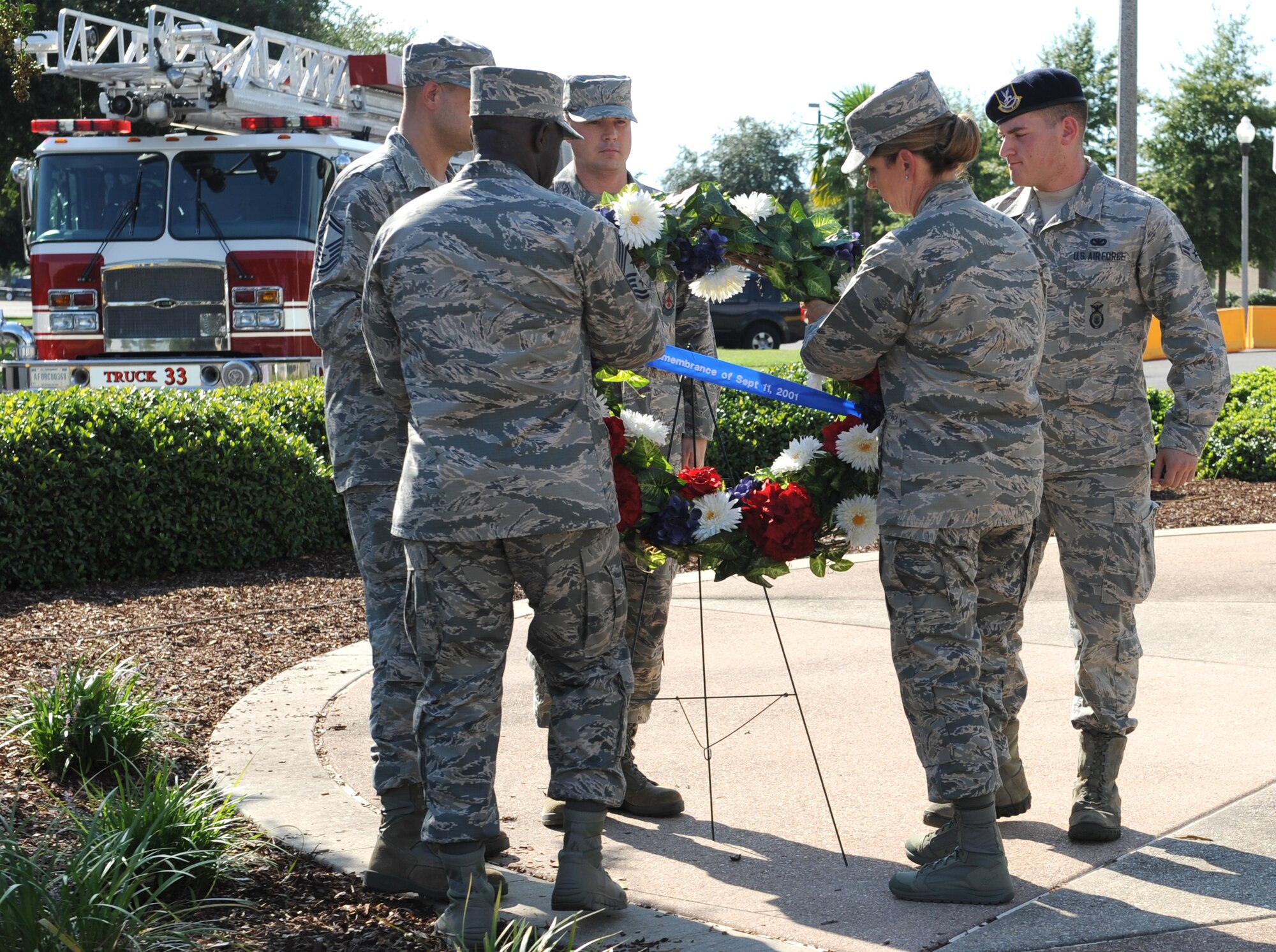Col. Michele Edmondson, 81st Training Wing commander, Chief Master Sgt. Vegas Clark, 81st TRW command chief, and Keesler emergency rescue members place a wreath on display during a 9/11 memorial ceremony, Sept. 12, 2016, on Keesler Air Force Base, Miss. Fifteen years ago on Sept. 11, 2001, 19 terrorists simultaneously hijacked four passenger jets; flying one into the Pentagon in Washington, D.C., two into the World Trade Center in New York City, New York and one crashing outside of Shanksville, Pa. A total of 2,996 people were killed in the attacks.  (U.S. Air Force photo by Kemberly Groue/Released)