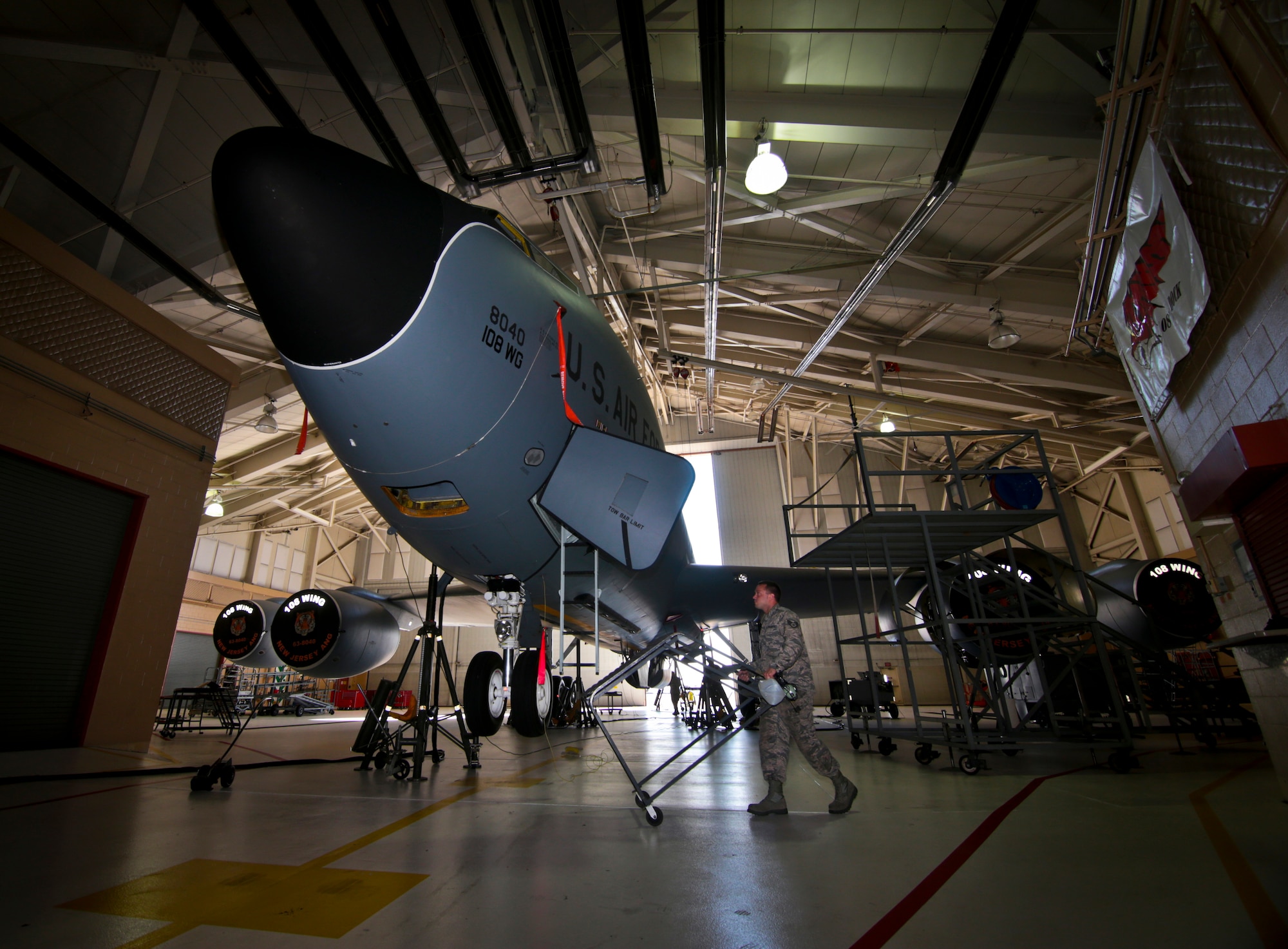 New Jersey Air National Guard Staff Sgt. David Spaeth moves a ladder during a landing gear test on a 108th Wing KC-135 Stratotanker at Joint Base McGuire-Dix-Lakehurst, N.J., August 31, 2016. The KC-135 is celebrating its 60th Anniversary today, having made its first flight on August 31, 1956. (U.S. Air National Guard photo by Tech. Sgt. Matt Hecht/Released)