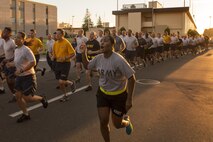 Army 1st Sgt. Donna Cook, US Forces, Japan first sergeant, shouts cadence during the USFJ Command 5K Run at Yokota Air Base, Japan, Sept. 9, 2016. Over 100 service member participated in the run, which concluded with the retirement of the old USFJ colors and the unveiling of the new USFJ colors. (U.S. Air Force photo by Yasuo Osakabe/Released) 