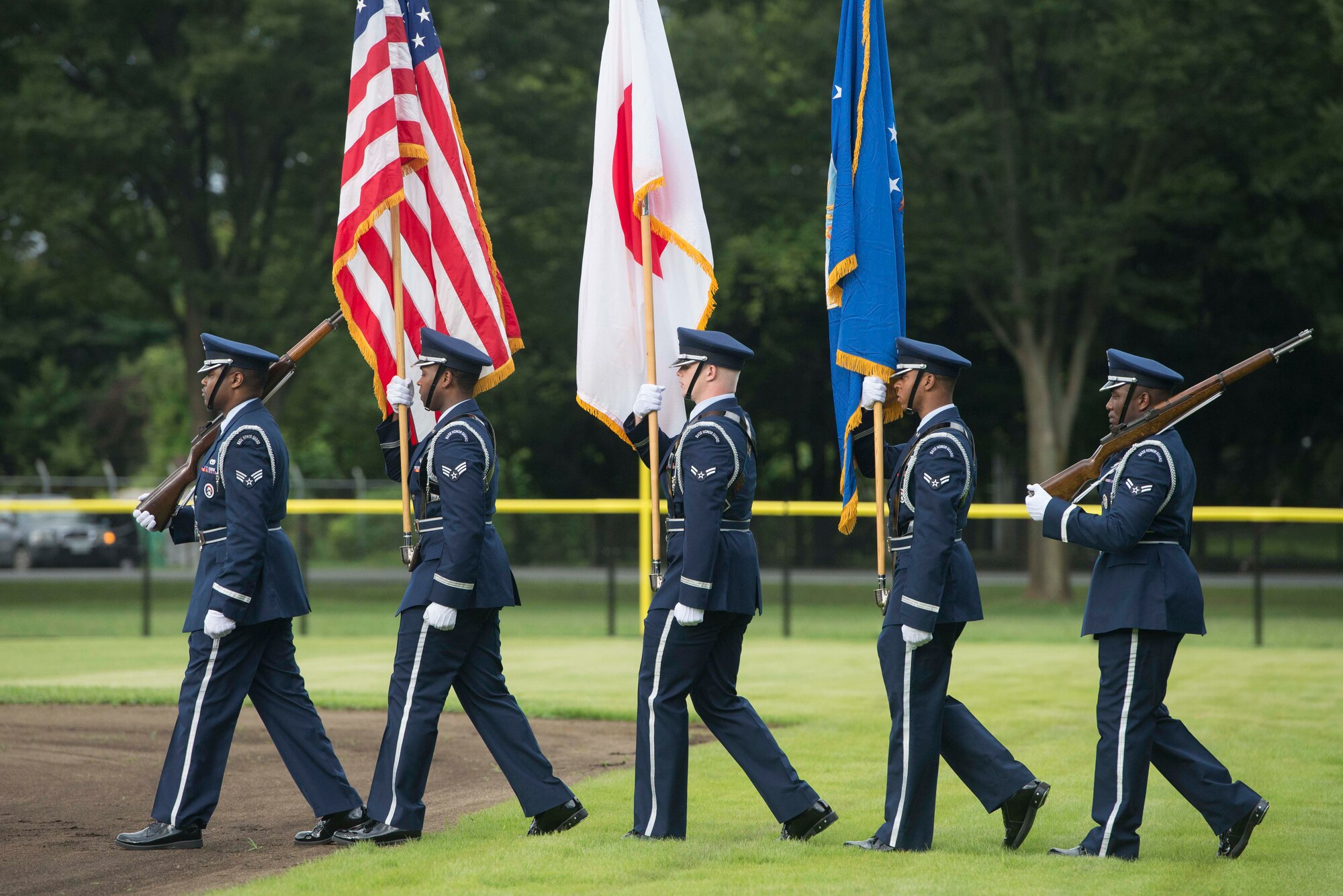 The Yokota Honor Guard marches onto Yokota Field, Sept. 9, 2016. Yokota commanders and chief master sergeants hosted a baseball game to celebrate the opening of the field. (U.S. Air Force by Senior Airman Delano Scott/Released)