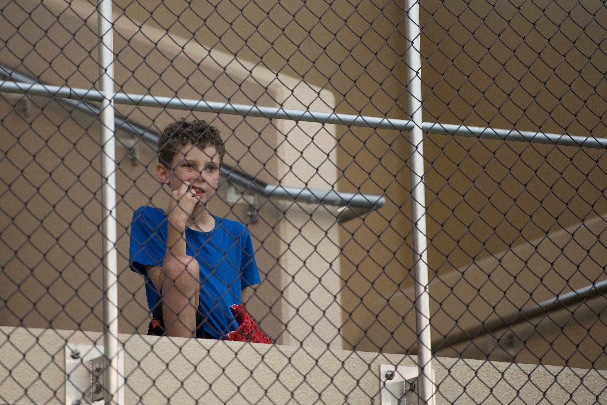 A child watches the Yokota Eagles vs. Chiefs baseball game from the stands of the Yokota Field stadium, Sept. 9, 2016. Airmen and their families celebrated the field’s opening with food, games and competitive baseball between Yokota’s colonels and chief master sergeants. (U.S. Air Force by Senior Airman Delano Scott/Released)