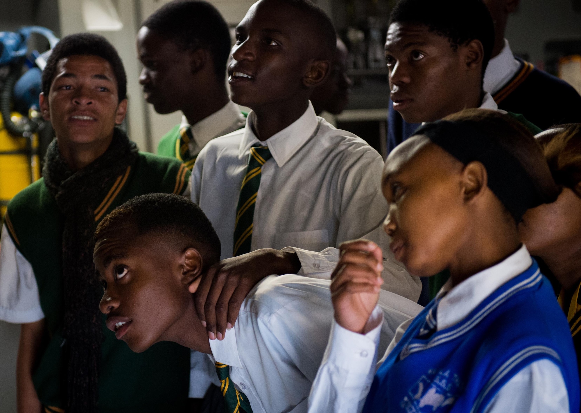 South African students anxiously wait to sit in the cockpit of a C-17 Globemaster III at the African Aerospace and Defense Expo at Waterkloof Air Force Base, South Africa, Sept. 14, 2016. The U.S. military is exhibiting a C-17 Globemaster III, a KC-135 Stratotanker, a C-130J Super Hercules, an HC-130 King, and an MQ-9 Reaper. The aircraft come from various Air National Guard and Air Force Reserve Command units. The U.S. routinely participates in events like AADE to strengthen partnerships with regional partners. (U.S. Air Force photo by Tech. Sgt. Ryan Crane)