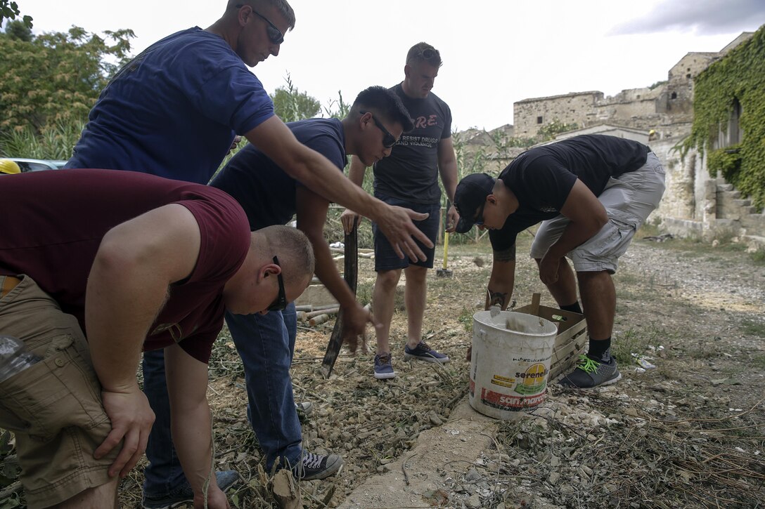 Marines with Special Purpose Marine Air-Ground Task Force Crisis Response-Africa, gather rocks and branches in Vizzini, Sicily, Sept. 7, 2016.  Marines volunteered to clean up a local historic site and build fences during a community relations project.  (U.S. Marine Corps photo by Cpl. Alexander Mitchell/released)
