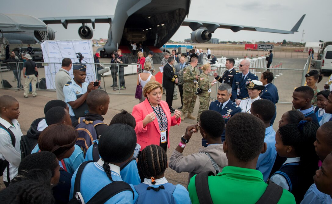 Ms. Heidi Grant, deputy under secretary for international affairs, speaks to a group of South African students who were touring U.S. military aircraft at the African Aerospace and Defense Expo at Waterkloof Air Force Base, South Africa, Sept. 14, 2016. The U.S. military is exhibiting a C-17 Globemaster III, a KC-135 Stratotanker, a C-130J Super Hercules, an HC-130 King, and an MQ-9 Reaper. The aircraft come from various Air National Guard and Air Force Reserve Command units. The U.S. routinely participates in events like AADE to strengthen partnerships with regional partners. (U.S. Air Force photo by Tech. Sgt. Ryan Crane)
