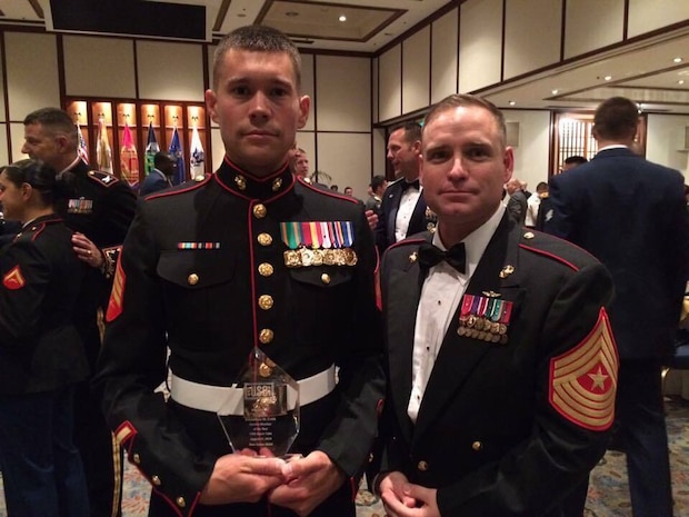 U.S. Marine Corps Sgt. Johnathan M. Cobb, left, patrol supervisor for the Provost Marshal’s Office at Marine Corps Air Station Iwakuni, and U.S. Marine Corps Sgt. Major Christopher J. Garza, station sergeant major, pose for a photo at the USO Japan Ninth Annual Service Salute Gala in Tokyo, Japan, Aug. 27, 2016. Cobb exceeded all criteria and represented MCAS Iwakuni at the Service Salute Gala as the air station’s Marine of the year. (U.S. Marine Corps courtesy photo)