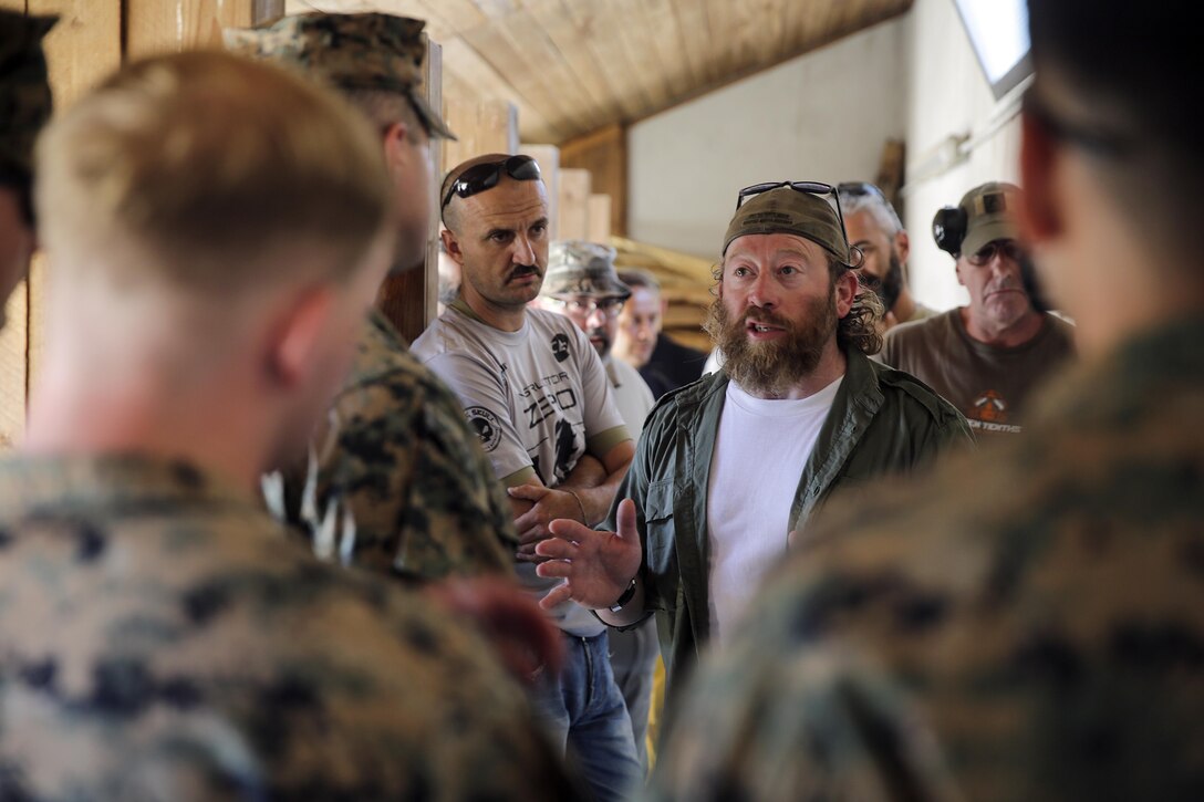 Instructor Zero, a chief instructor for Spartan 360 Tactical Defense speaks to Marines with Special Purpose Marine Air-Ground Task Force Crisis Response-Africa at a range near Naval Air Station Sigonella, Italy, Sept. 10, 2016.  Marines with SPMAGTF-CR-AF took an advanced shooting course with Instructor Zero, who went over fundamentals and tactics of firing a pistol.  (U.S. Marine Corps photo by Cpl. Alexander Mitchell/released)