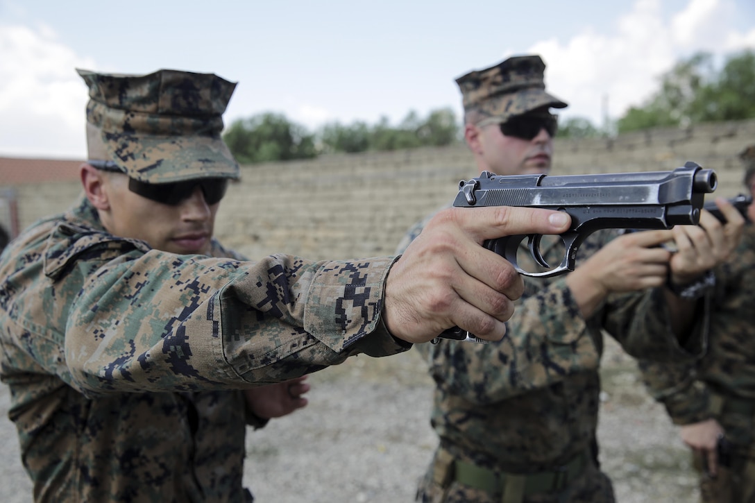 Sgt. Spencer Jimick, a squad leader with Special Purpose Marine Air-Ground Task Force Crisis Response-Africa aims his M9 Beretta at a target during a live-fire range near Naval Air Station Sigonella, Italy, Sept. 10, 2016.  Marines with SPMAGTF-CR-AF took an advanced shooting course with Instructor Zero, a chief instructor with Spartan 360 Tactical Defense, who went over fundamentals and tactics of firing a handgun.  (U.S. Marine Corps photo by Cpl. Alexander Mitchell/released)