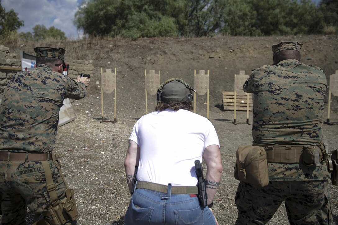 Instructor Zero, a chief instructor for Spartan 360 Tactical Defense, watches as two Marines with Special Purpose Marine Air-Ground Task Force Crisis Response-Africa fire at a target during a live-fire range near Naval Air Station Sigonella, Italy, Sept. 10, 2016.  Marines with SPMAGTF-CR-AF took an advanced shooting course with Instructor Zero, who went over fundamentals and tactics of firing a handgun.  (U.S. Marine Corps photo by Cpl. Alexander Mitchell/released)