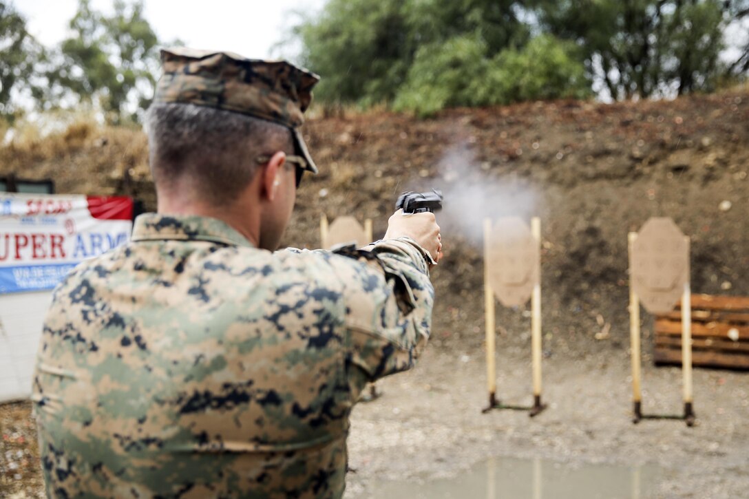 Cpl. Steven Signorello, a team leader with Special Purpose Marine Air-Ground Task Force Crisis Response-Africa fires his M9 Beretta at a target during a live-fire range near Naval Air Station Sigonella, Italy, Sept. 10, 2016.  Marines with SPMAGTF-CR-AF took an advanced shooting course with Instructor Zero, a chief instructor with Spartan 360 Tactical Defense, who went over fundamentals and tactics of firing a handgun.  (U.S. Marine Corps photo by Cpl. Alexander Mitchell/released)