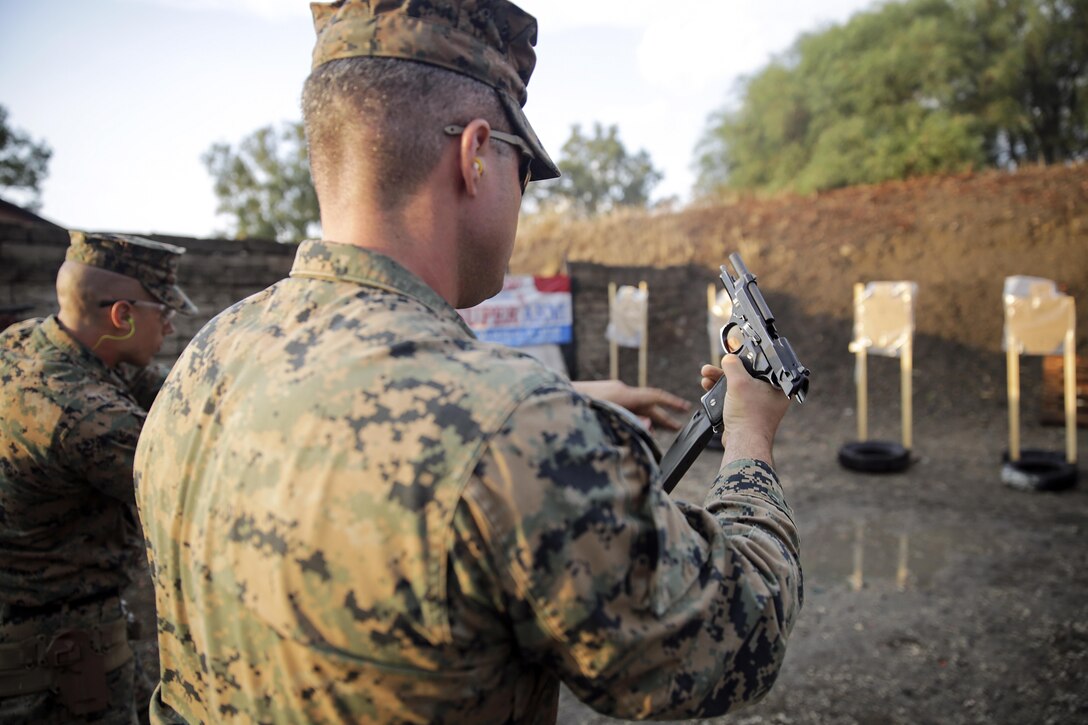 Cpl. Steven Signorello, a team leader with Special Purpose Marine Air-Ground Task Force Crisis Response-Africa performs a speed reload during a live-fire range near Naval Air Station Sigonella, Italy, Sept. 10, 2016.  Marines with SPMAGTF-CR-AF took an advanced shooting course with Instructor Zero, a chief instructor with Spartan 360 Tactical Defense, who went over fundamentals and tactics of firing a handgun.  (U.S. Marine Corps photo by Cpl. Alexander Mitchell/released)