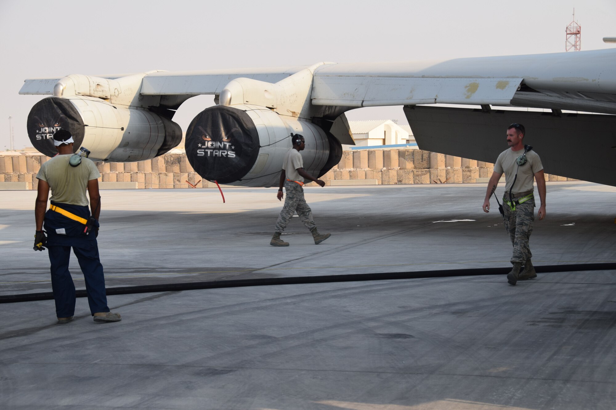 Crew chiefs from the 7th Expeditionary Air Mobility Unit prepare to load fuel onto a E-8C Joint Surveillance Target Attack Radar System prior to a mission on Sept. 12, 2016, at Al Udeid Air Base, Qatar. The crew chiefs from the 7th Expeditionary Air Mobility Unit are deployed here from Robins Air Force Base, Ga. NCO in charge Senior Master Sgt. Frederick Mabry (center), Staff Sgts. Michael Edwards (left) and Dustin Miller(right) prepared the JSTARS for a combat mission later on that evening. (U.S. Air Force photo/Tech. Sgt. Carlos J. Trevino/Released) 