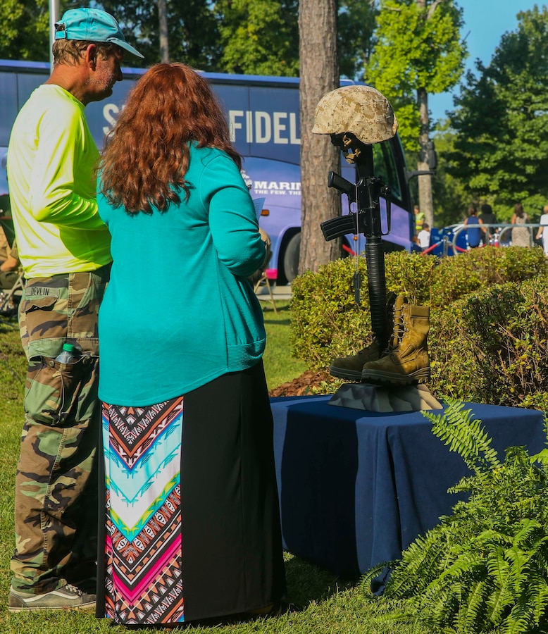 Two members of the Jacksonville community pay their respect to the representation of fallen Marines in the aftermath of the Sept. 11, 2001 attacks at the Lejeune Memorial Gardens during the Patriot Day Observance Ceremony on Marine Corps Base Camp Lejeune, Sept. 11, 2016. The community stood together to remember the victims of the Sept. 11, 2001 terrorist attacks during the 15 year anniversary.
