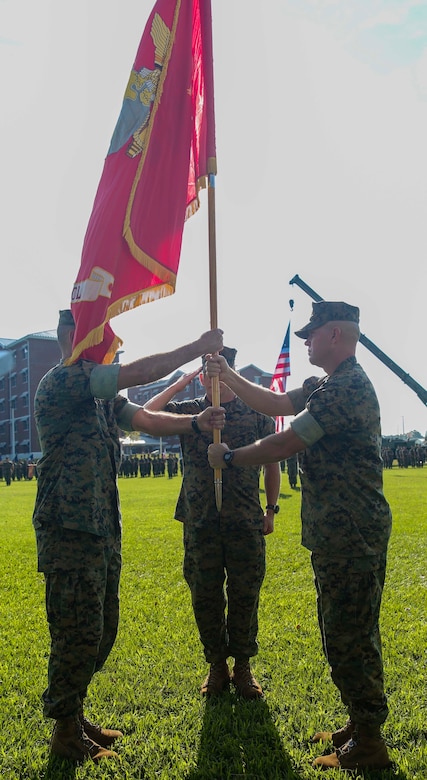 Col. Scott A. Baldwin, right, Marine Corps Engineer School outgoing commanding officer, passes the unit colors to Col. Daniel P. O’Hora, left, Marine Corps Engineer School incoming commanding officer, at Courthouse Bay on Marine Corps Base Camp Lejeune, Sept. 9. The mission of the Marine Corps Engineer School is to ingrain at the entry and supervisory level the skills needed for engineers to be prepared for the operating forces.