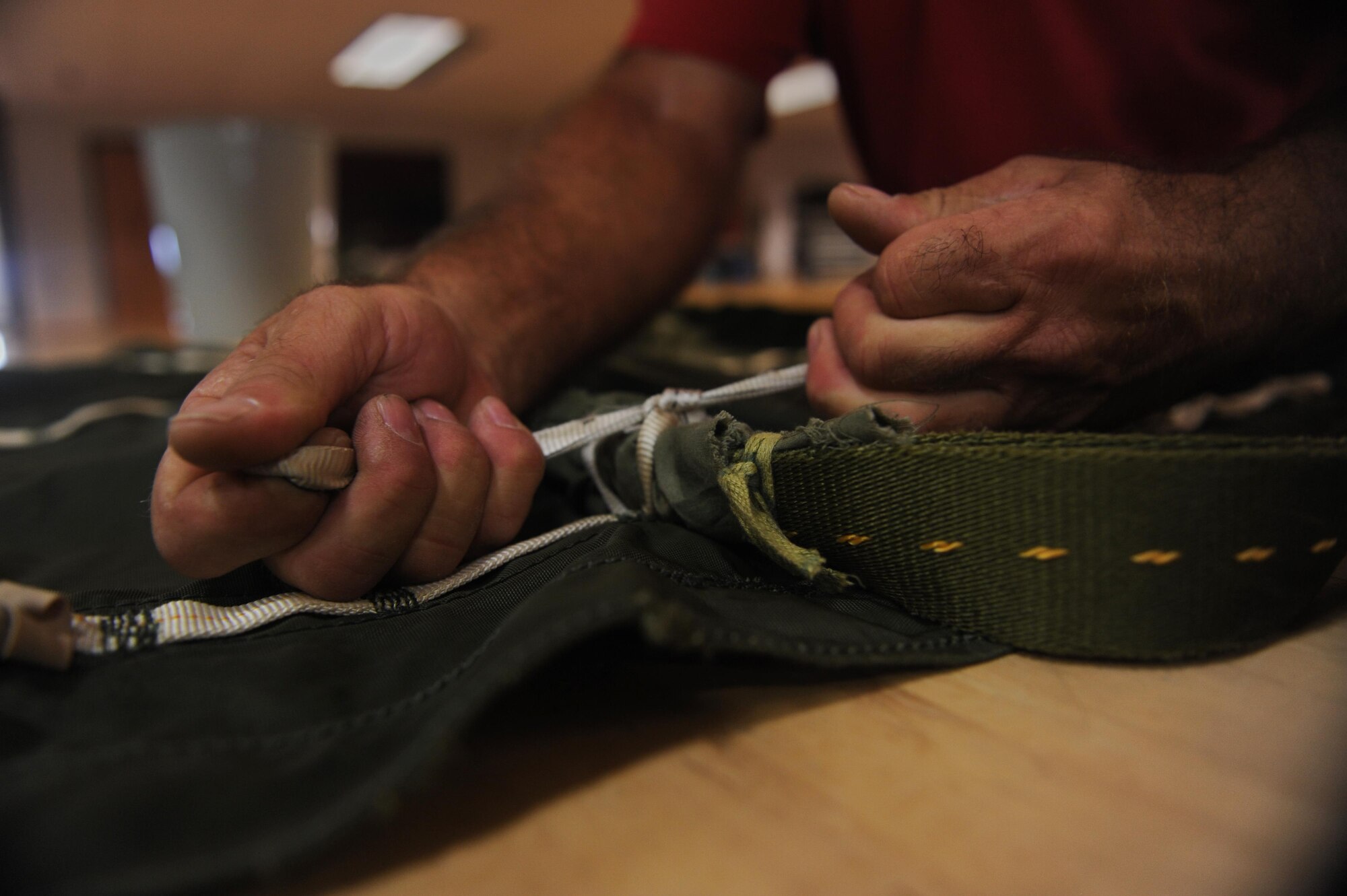 A U.S Air Force 19th Logistics Readiness Squadron Aerial Delivery parachute rigger secures a parachute Sept. 9, 2016, at Hangar 259 on Little Rock Air Force Base, Ark. The aerial delivery team at Little Rock Air Force Base performs fifty-eight percent of the Department of Defense's unilateral airdrop training.