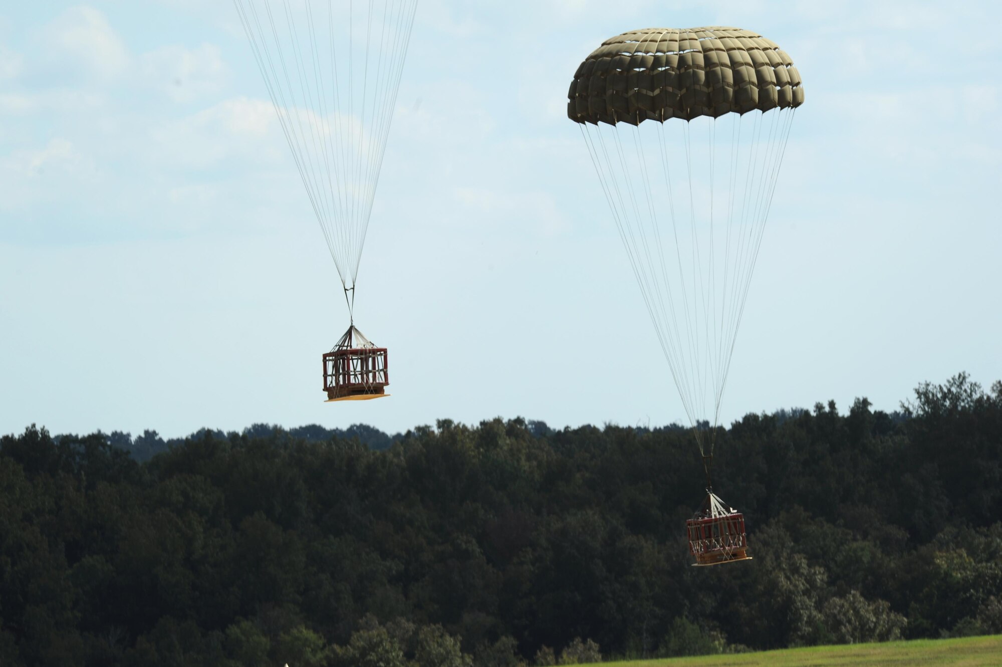 Parachutes deliver cargo platforms to ground forces Sept. 12, 2016, at a drop zone in central Arkansas. Each parachute must be checked for holes or broken lines prior to use. 